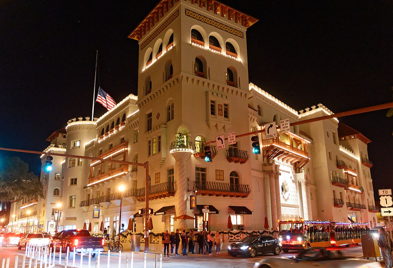 Casa Monica Hotel’s illuminated towers and balconies beneath a dark sky in St. Augustine