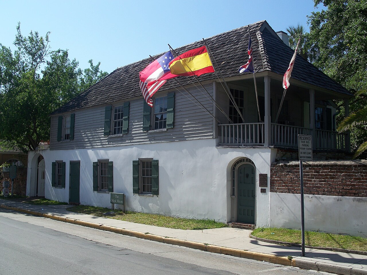 González–Álvarez House in St. Augustine, with green shutters and a white lower facade