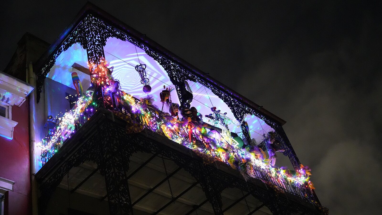 French Quarter balcony illuminated during a night tour